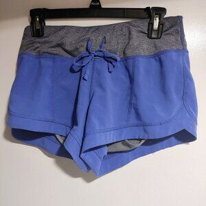 Purple athletic drawstring booty shorts.